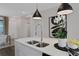 Modern kitchen island featuring a stainless steel faucet, dual sinks, pendant lights, and stylish decor at 13108 Serene Glade Rd, Winter Garden, FL 34787