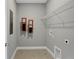 Neutral laundry room with utility connections and wire shelving for ample storage at 13108 Serene Glade Rd, Winter Garden, FL 34787