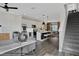 Open-concept living room and kitchen, featuring modern furnishings, a kitchen island, and a staircase at 13108 Serene Glade Rd, Winter Garden, FL 34787