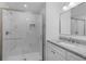 Modern bathroom featuring a glass-enclosed shower and granite-topped vanity at 1421 E Schwartz Blvd, The Villages, FL 32159