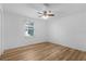 Bedroom with a ceiling fan, hardwood floors and window at 1421 E Schwartz Blvd, The Villages, FL 32159