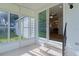 Enclosed porch showcasing access to the home's interior through sliding glass doors at 1421 E Schwartz Blvd, The Villages, FL 32159