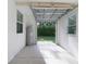 Bright garage interior featuring a water heater and open door to the lush backyard at 1421 E Schwartz Blvd, The Villages, FL 32159
