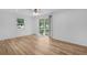 Spacious living room with wood-look floors, ceiling fan and sliding glass doors at 1421 E Schwartz Blvd, The Villages, FL 32159