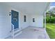 Covered patio with blue accent door at 1421 E Schwartz Blvd, The Villages, FL 32159