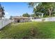 Fenced backyard with a lush lawn, a patio, and mature trees at 149 Shiloh Ave, Lady Lake, FL 32159