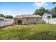 Large backyard featuring a patio with outdoor seating and a well-maintained lawn at 149 Shiloh Ave, Lady Lake, FL 32159