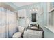 Bright bathroom featuring blue walls, a vanity with a black countertop, and coordinated fixtures at 149 Shiloh Ave, Lady Lake, FL 32159