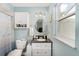 Bright bathroom featuring blue walls, a vanity with a black countertop, and coordinated fixtures at 149 Shiloh Ave, Lady Lake, FL 32159