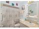 Bathroom showcasing a shower with unique shower curtain and accessibility features at 149 Shiloh Ave, Lady Lake, FL 32159