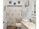 Bathroom showcasing a shower with unique shower curtain and accessibility features at 149 Shiloh Ave, Lady Lake, FL 32159
