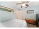Clean bedroom with wood floors, a ceiling fan, and decor at 149 Shiloh Ave, Lady Lake, FL 32159