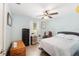 Comfortable bedroom featuring wood floors, a ceiling fan, and a bed with pillows at 149 Shiloh Ave, Lady Lake, FL 32159