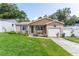 Charming home featuring a manicured lawn, brick accents, and an inviting covered porch with seating at 149 Shiloh Ave, Lady Lake, FL 32159