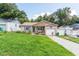 Charming home featuring a manicured lawn, brick accents, and an inviting covered porch with seating at 149 Shiloh Ave, Lady Lake, FL 32159