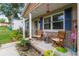 Inviting front porch with chairs, plants, and decor, creating a cozy outdoor space at 149 Shiloh Ave, Lady Lake, FL 32159