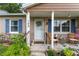 Inviting front porch with chairs, plants, and decor, creating a cozy outdoor space at 149 Shiloh Ave, Lady Lake, FL 32159
