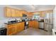 Functional kitchen with wooden cabinets, stainless steel appliances, and durable black countertops at 149 Shiloh Ave, Lady Lake, FL 32159