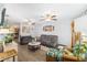 Cozy living room with comfortable seating, wood-look floors, and a bright, open layout at 149 Shiloh Ave, Lady Lake, FL 32159