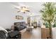 Cozy living room featuring hardwood floors, ceiling fans, and comfortable seating arrangements at 149 Shiloh Ave, Lady Lake, FL 32159