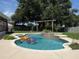 Inviting backyard pool with a waterfall feature and colorful inflatables at 15349 Lafite Ln, Clermont, FL 34714