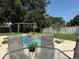 Backyard pool with lounge area and privacy fence on a sunny day at 15349 Lafite Ln, Clermont, FL 34714