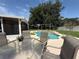 Backyard pool with lounge area and privacy fence viewed from a patio at 15349 Lafite Ln, Clermont, FL 34714