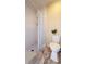 Bright bathroom featuring a white tiled shower, toilet, and neutral tones at 15349 Lafite Ln, Clermont, FL 34714