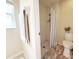 Bathroom featuring a walk-in shower with a white and black shower curtain and a toilet at 15349 Lafite Ln, Clermont, FL 34714
