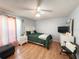 Cozy bedroom with a bed, ceiling fan, and white dresser with a television at 15349 Lafite Ln, Clermont, FL 34714