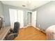 Neutral-toned bedroom with ample closet space and wood laminate flooring at 15349 Lafite Ln, Clermont, FL 34714