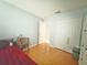 Spacious bedroom with wood floors, closet, and open doorway at 15349 Lafite Ln, Clermont, FL 34714