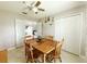 Charming dining room with wood table, ceiling fan and bright lighting at 15349 Lafite Ln, Clermont, FL 34714