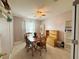 Well-lit dining room with a classic wood table and white tile floors at 15349 Lafite Ln, Clermont, FL 34714