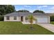 Charming single-story home featuring well-maintained landscaping and a classic design at 15349 Lafite Ln, Clermont, FL 34714