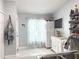 Bright kitchen featuring tile floors, a window with curtains, white cabinets, and open shelving at 15349 Lafite Ln, Clermont, FL 34714