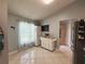 View of kitchen featuring tile floors, a window with curtains, and a white mobile cabinet at 15349 Lafite Ln, Clermont, FL 34714
