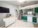 Spacious kitchen featuring stainless steel appliances, green cabinets, and tile flooring at 15349 Lafite Ln, Clermont, FL 34714