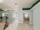 Open floor plan with tile flooring, green accents, and a view into the dining room and kitchen at 15349 Lafite Ln, Clermont, FL 34714