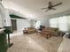 Comfortable living room with tile floors, ceiling fan, and an abundance of natural light at 15349 Lafite Ln, Clermont, FL 34714