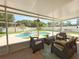 Screened patio with seating area overlooking a backyard pool at 15349 Lafite Ln, Clermont, FL 34714