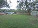 Large backyard offering plenty of space for outdoor activities, storage shed, and mature trees at 1610 Williams Ave, Eustis, FL 32726