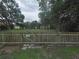 Backyard with a wooden fence and gate, providing privacy and security for your outdoor space at 1610 Williams Ave, Eustis, FL 32726