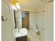 Well-lit bathroom featuring a vanity with sink, toilet, and a tiled shower at 1610 Williams Ave, Eustis, FL 32726