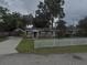 Charming single-story home featuring a well-maintained lawn, picket fence, and covered carport at 1610 Williams Ave, Eustis, FL 32726