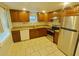 Well-equipped kitchen with wood cabinets, granite countertops, and stainless steel appliances at 1610 Williams Ave, Eustis, FL 32726
