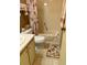 Bathroom with sink, toilet, walk-in shower, and decorative floral accents throughout at 163 Sweet Cir, Winter Haven, FL 33884