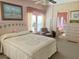 Bright bedroom with a bed, sitting chair, dresser, and view of the bathroom at 163 Sweet Cir, Winter Haven, FL 33884