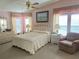 Charming bedroom with soft pink tones, featuring a comfy bed, dresser, and sunny windows at 163 Sweet Cir, Winter Haven, FL 33884
