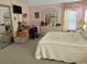 Well-lit bedroom featuring a bed, desk, dresser, and mirror, providing ample space and functionality at 163 Sweet Cir, Winter Haven, FL 33884